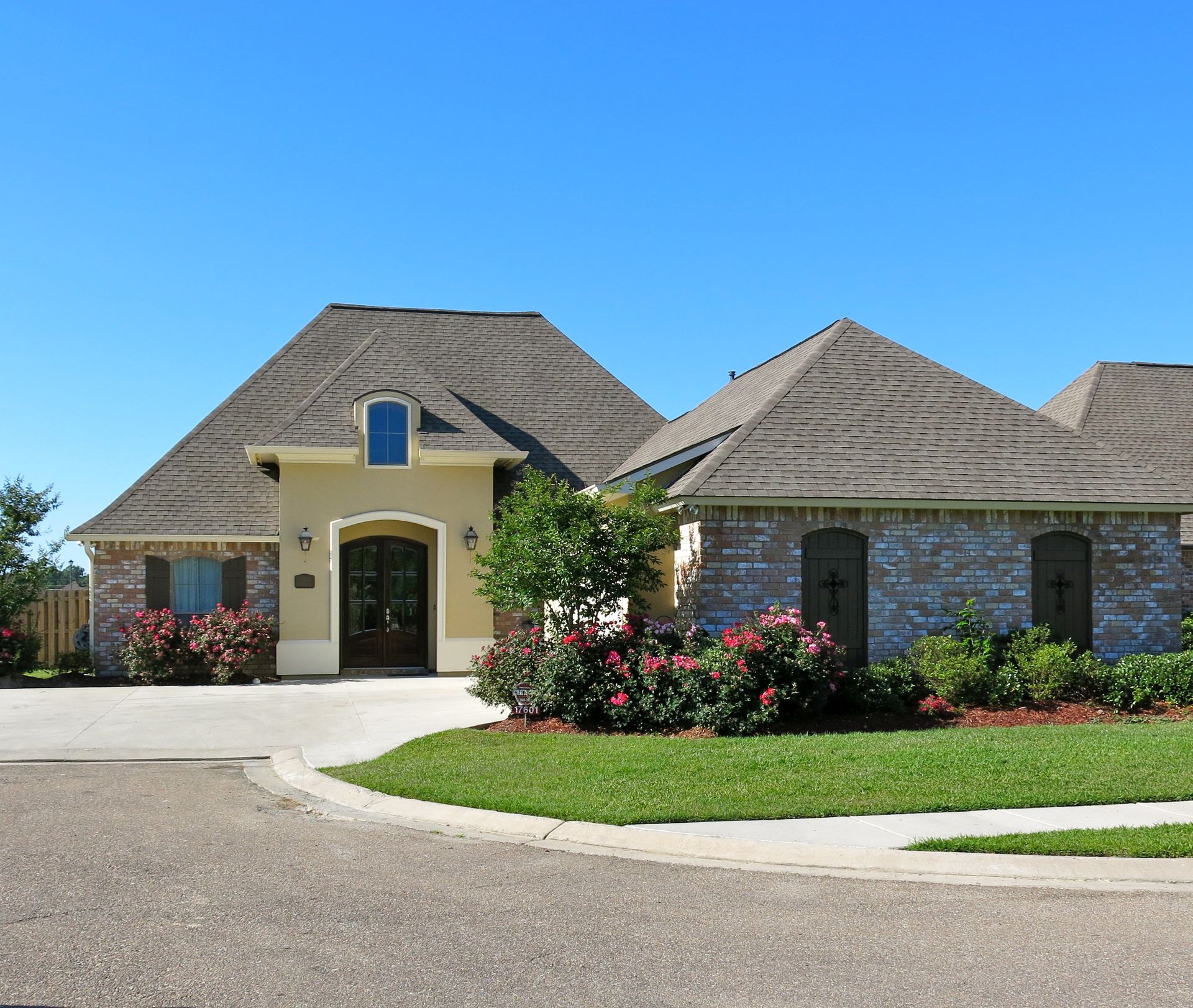 A house with a gray roof and a yellow facade