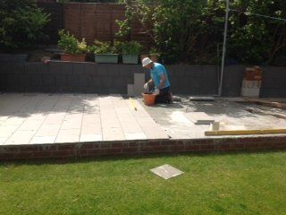 Worker laying a patio