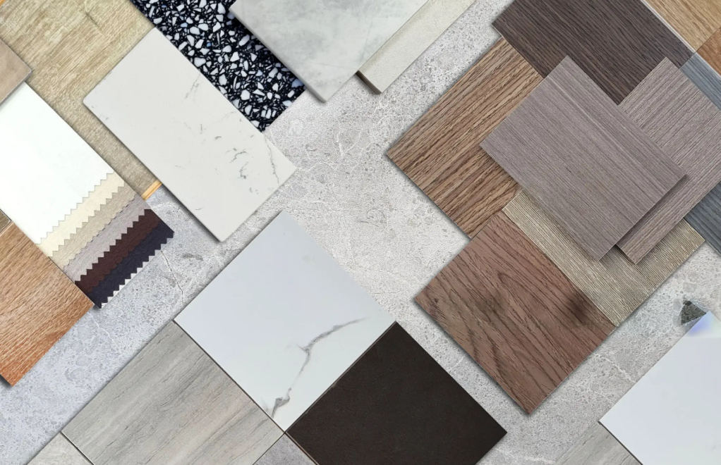 Assortment of wooden flooring samples in varying shades of brown, tan, and beige.
