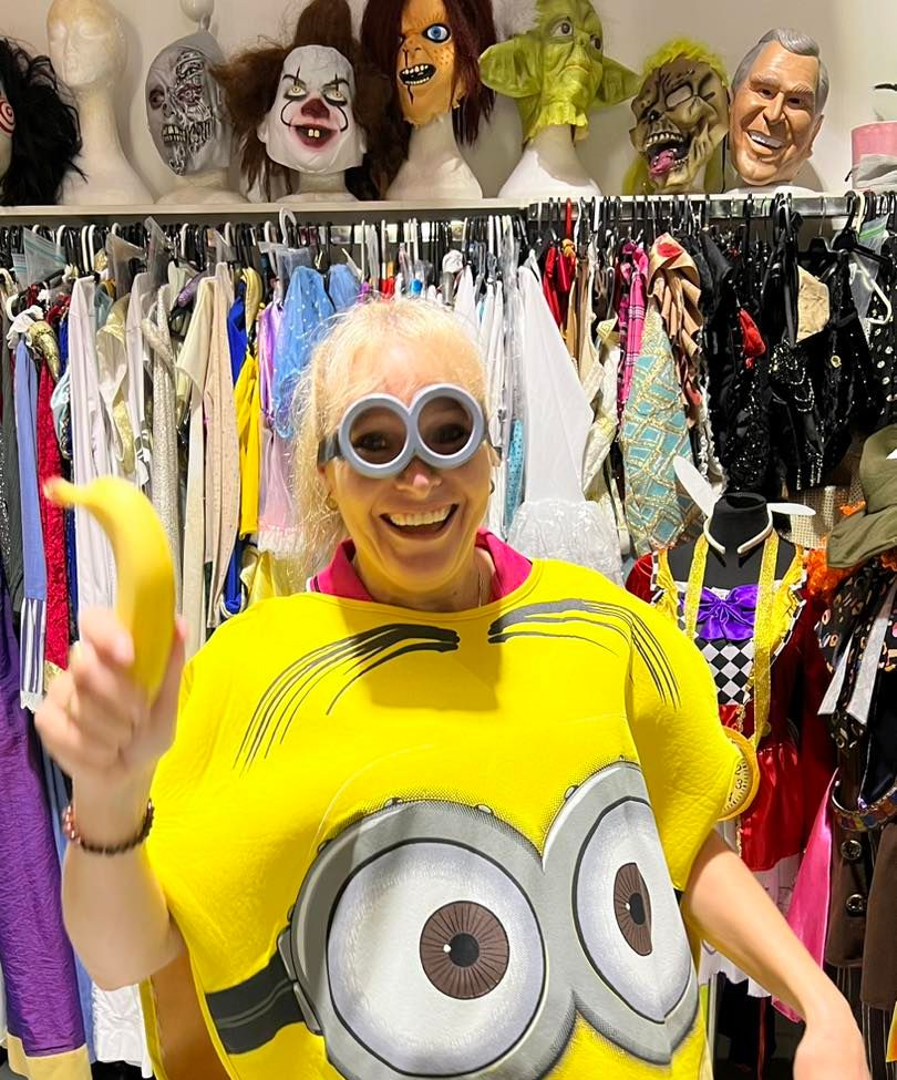 Woman in a Minion Costume Holding a Banana — Costumes Galore In Maroochydore, QLD