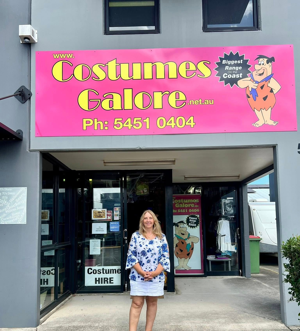 Woman Standing Outside the Pink Costumes Galore Costume Shop Entrance — Costumes Galore in Maroochydore, QLD