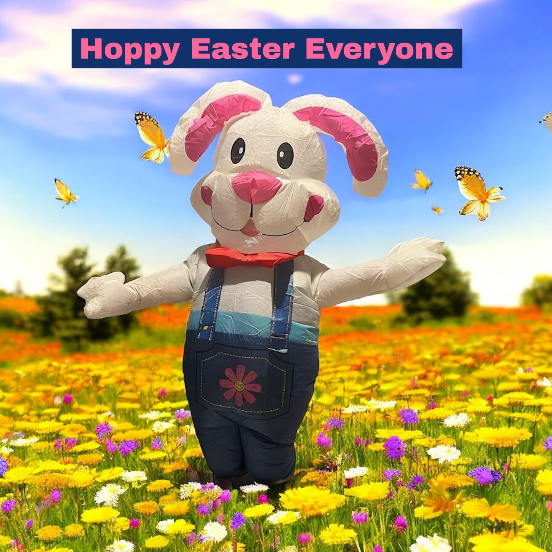 Inflatable Easter bunny wearing overalls in a field of wildflowers with butterflies. 