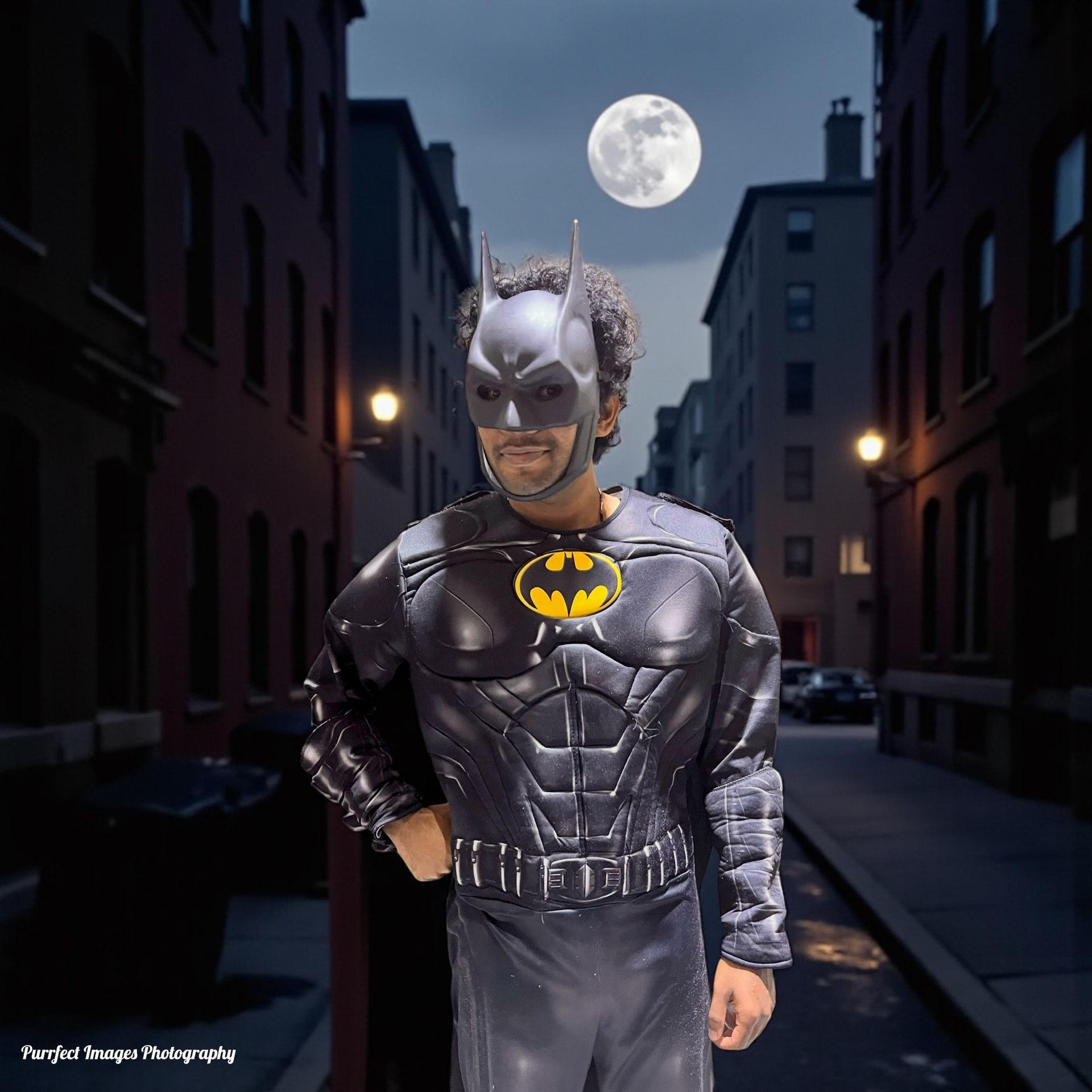 Man in Batman costume stands in an alley at night, moon in the sky — Costumes Galore In Maroochydore, QLD