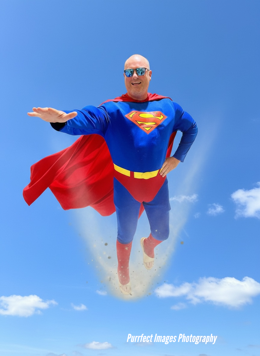 Man in Superman costume flying in a blue sky — Costumes Galore In Maroochydore, QLD