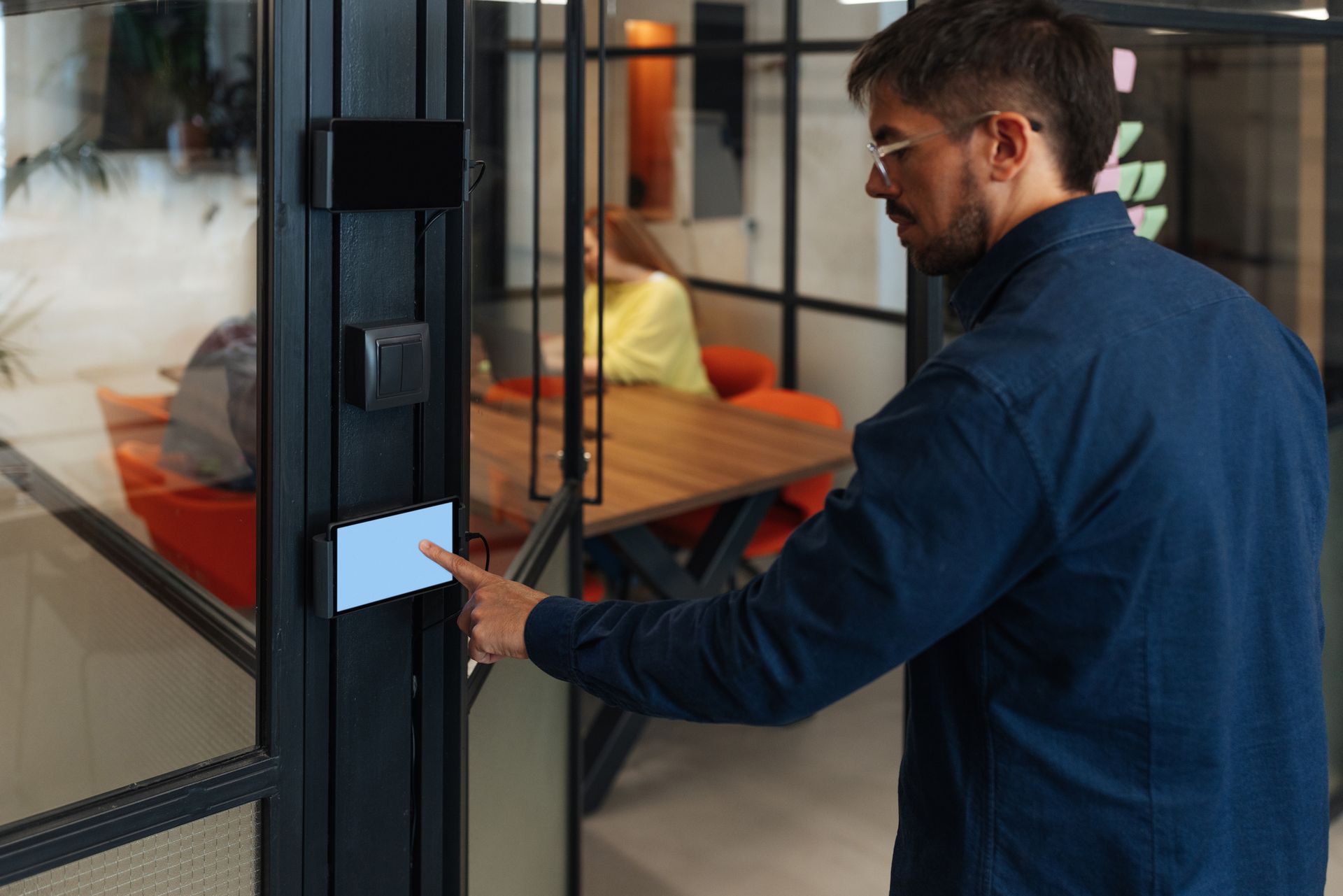 Businessman using electronic control panel for office access with blank screen. Businessman using electronic control panel for office access with blank screen.