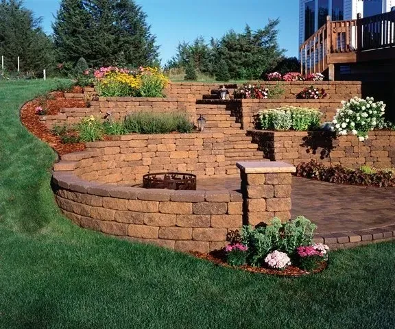 A backyard with a brick wall and stairs