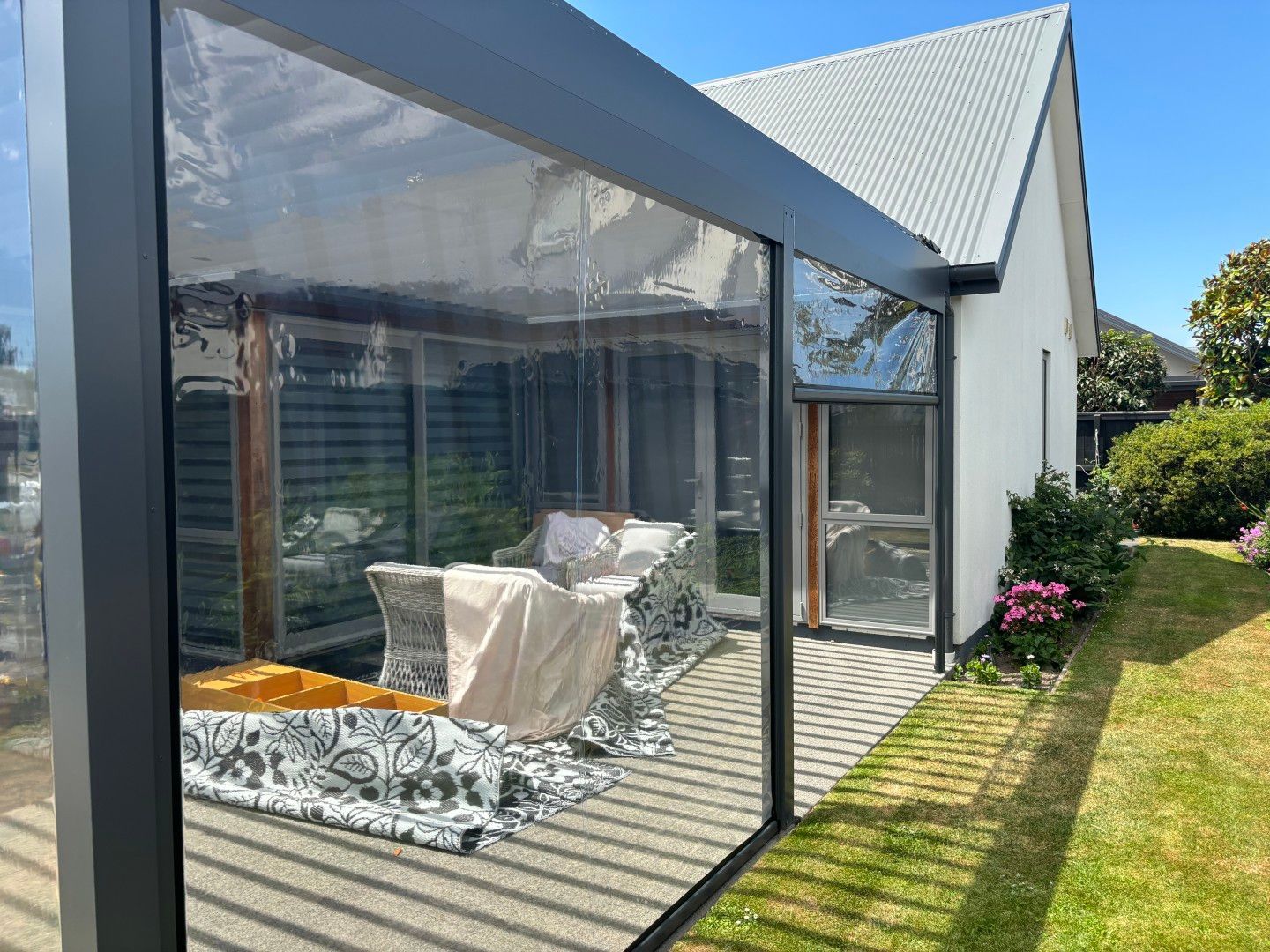 A house with a patio and a pergola in front of it.