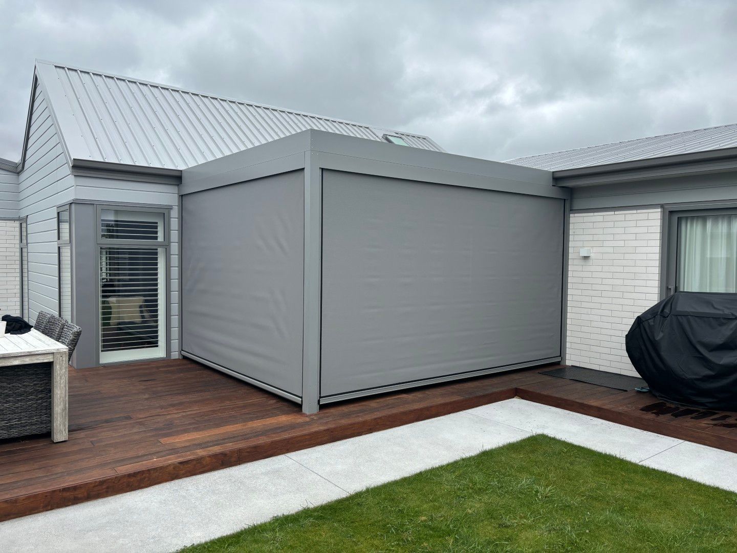 A house with a pergola on the side of it.