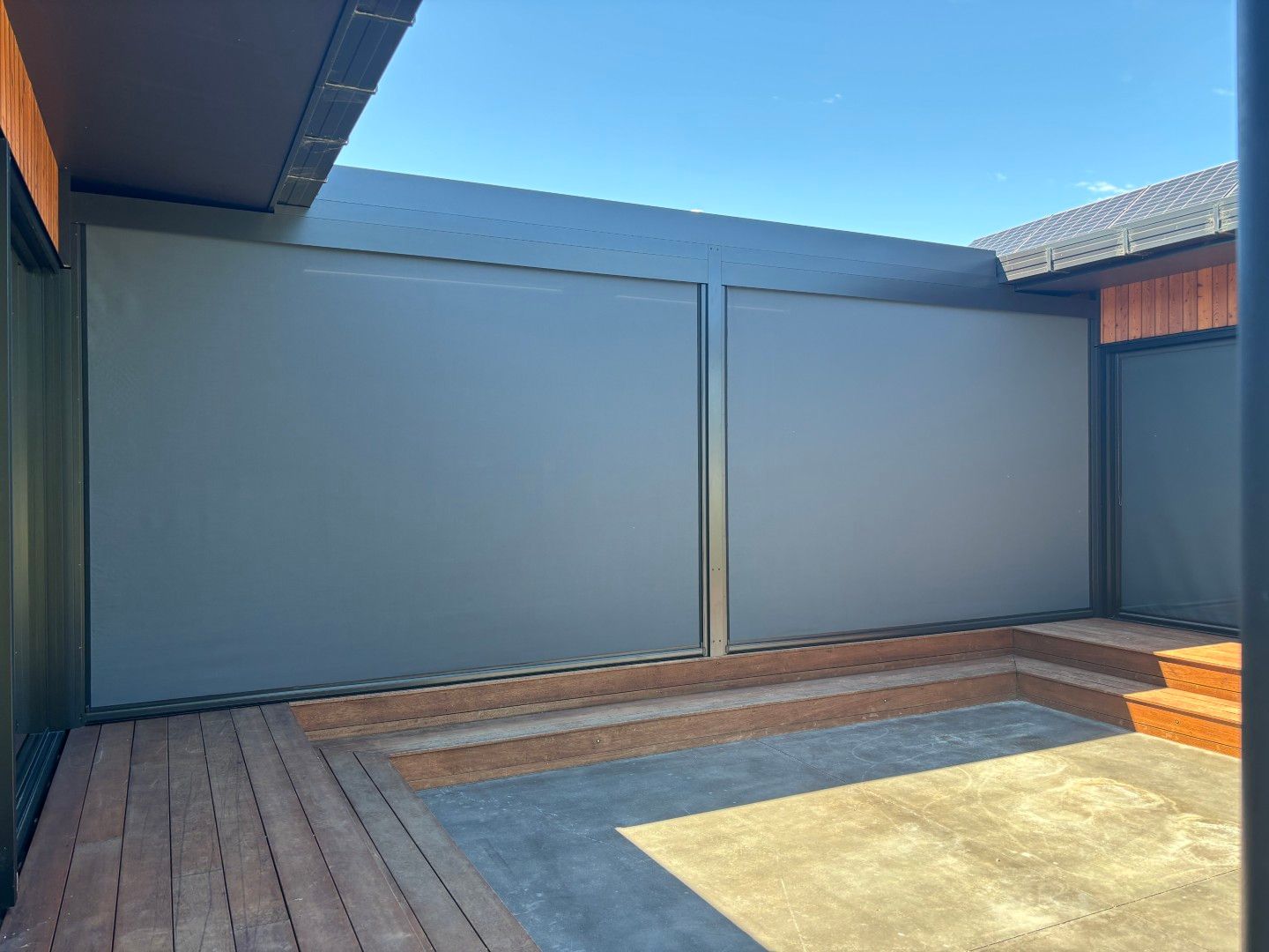 There is a fence in the backyard of a house.