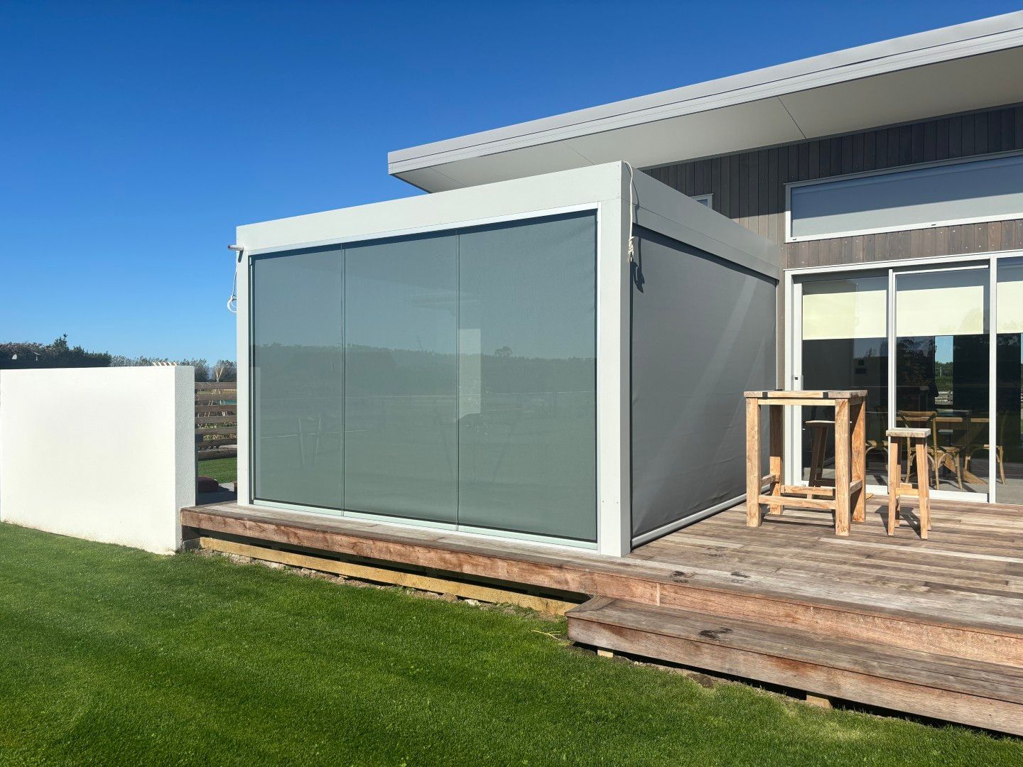 A house with a sliding glass door and a wooden deck.