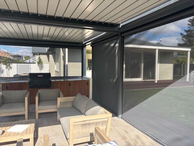 A living room with a couch , chairs and a table