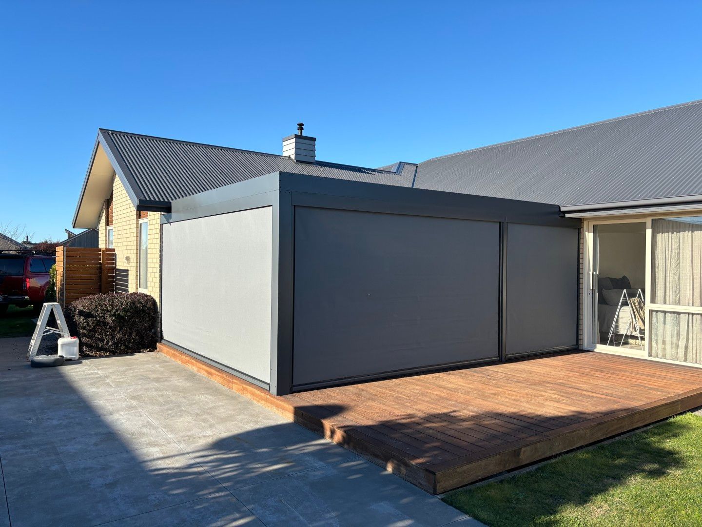 A house with a patio and a sliding screen door.