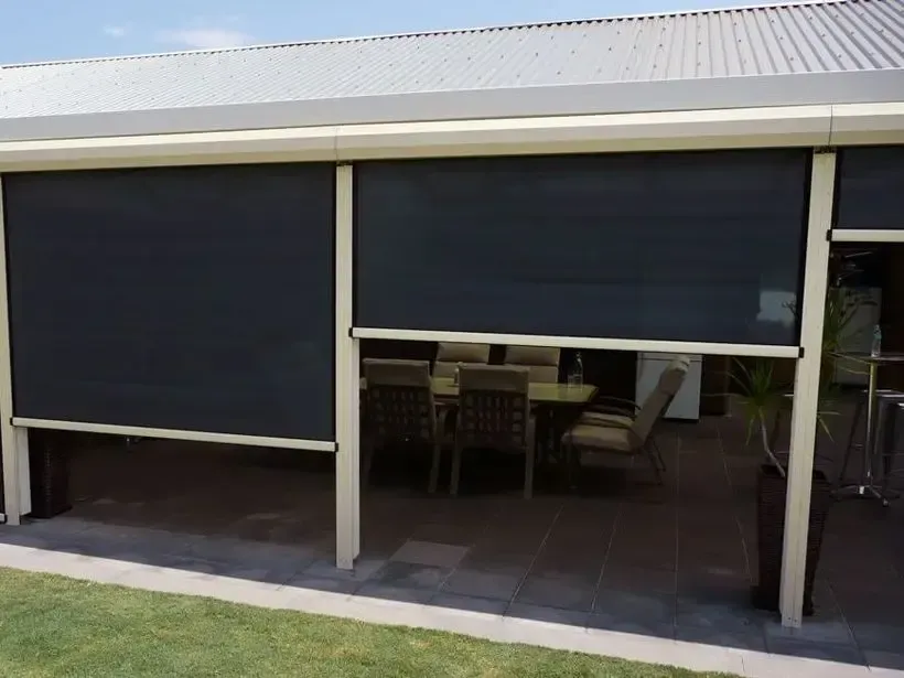 A house with a patio with a table and chairs on it.