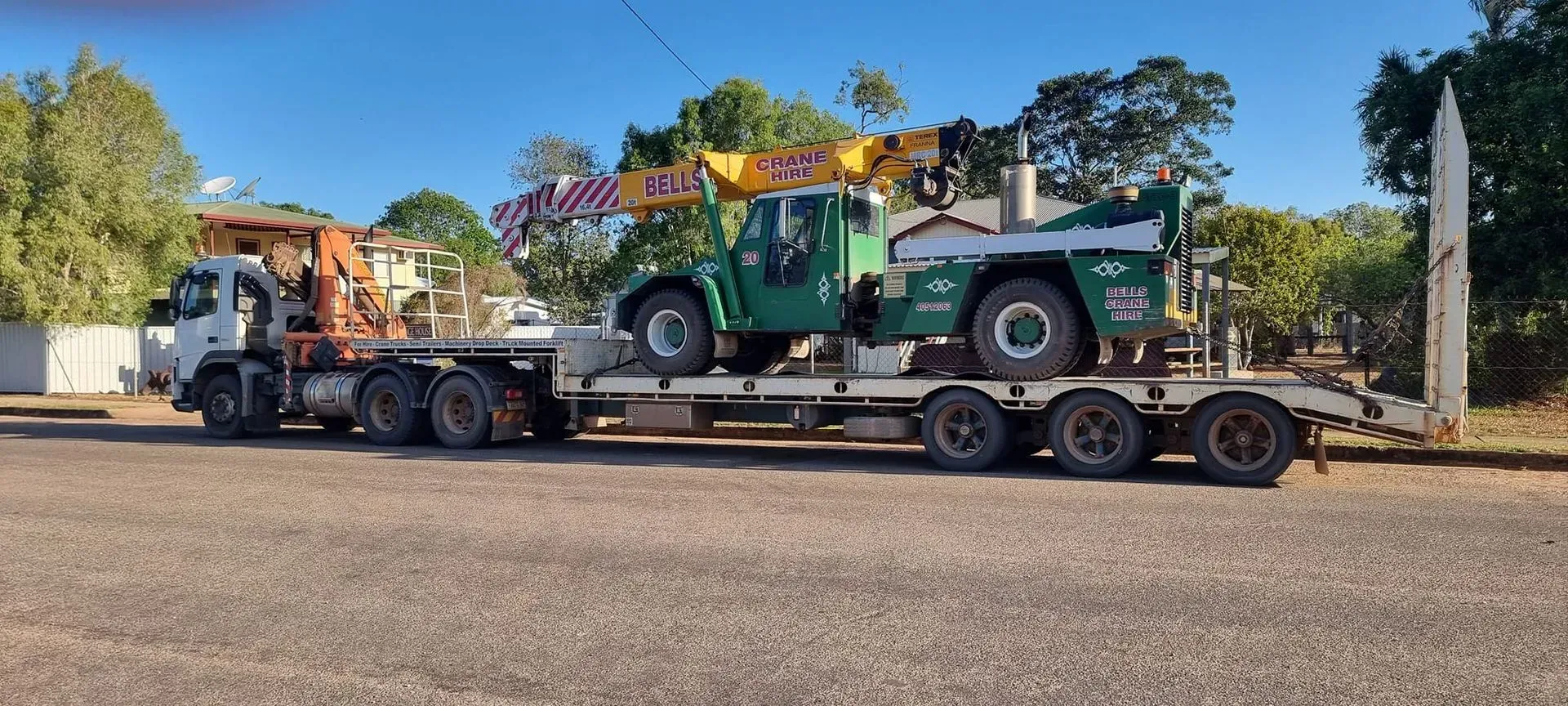 A Green Crane on a Flatbed Truck — Bell's Carrying & Crane Hire Service Pty Ltd in Normanton, QLD