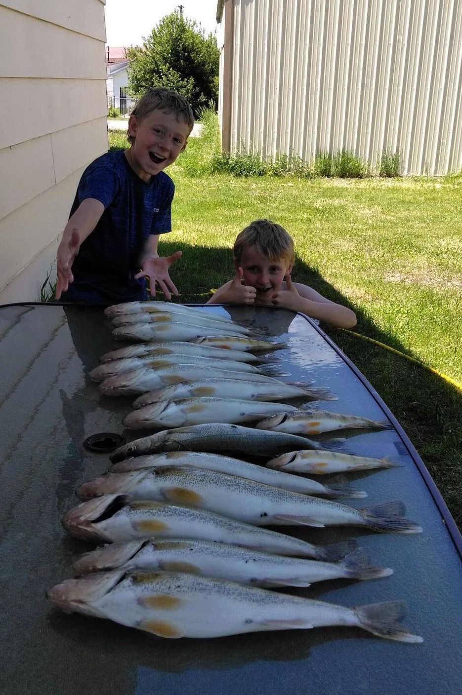 kids showing fish caught