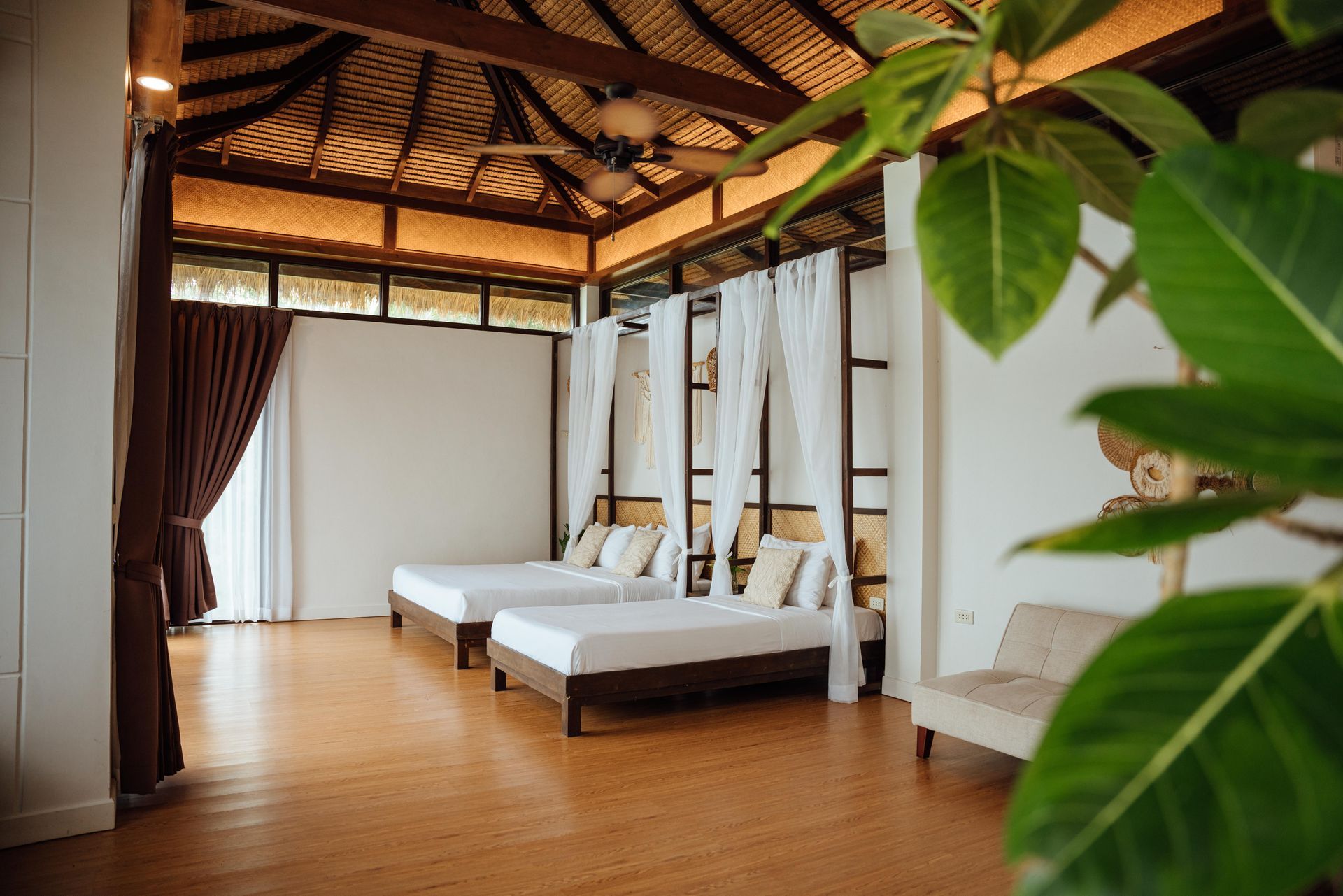 There are three beds in the room with a canopy.