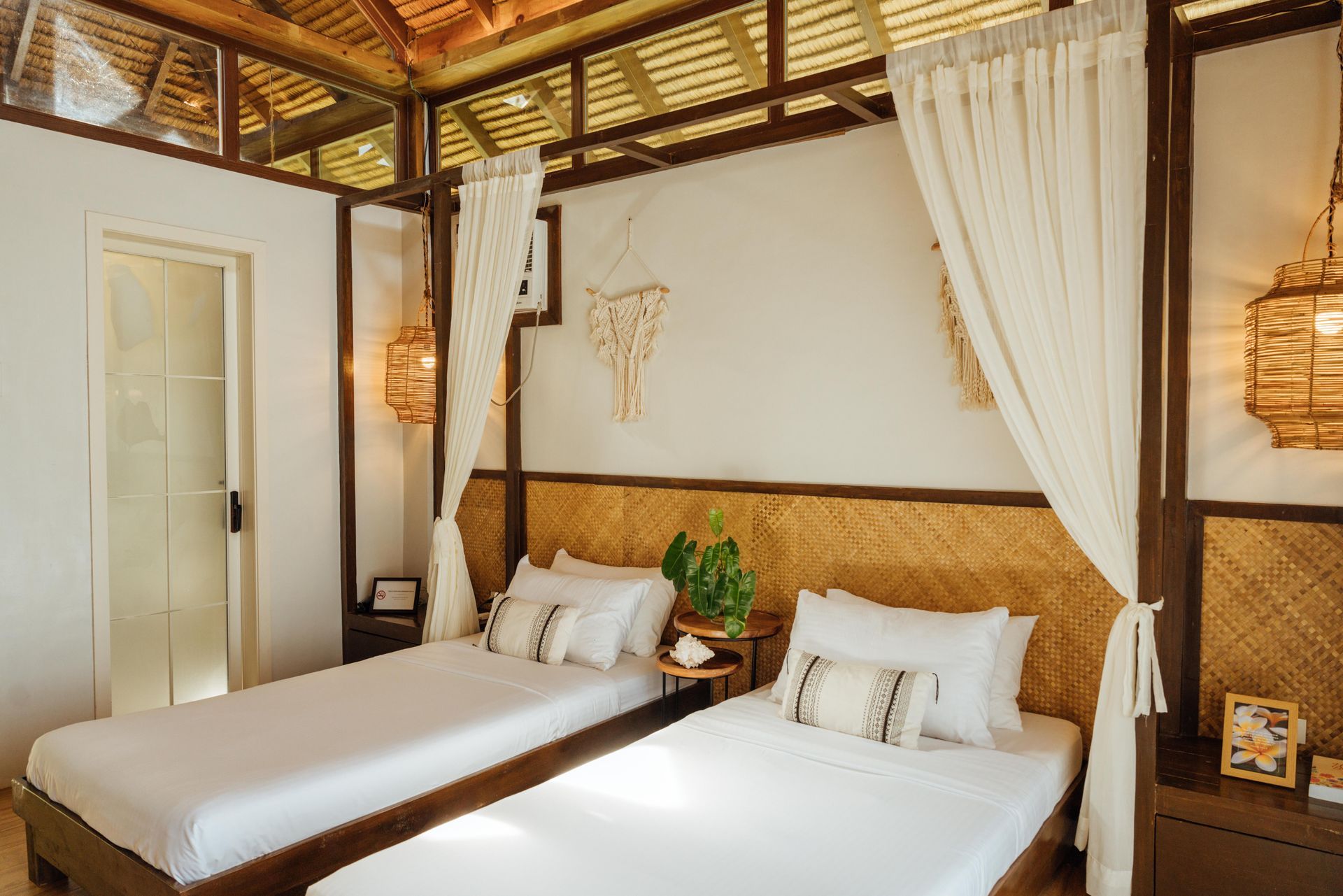A bedroom with two beds and a canopy bed.