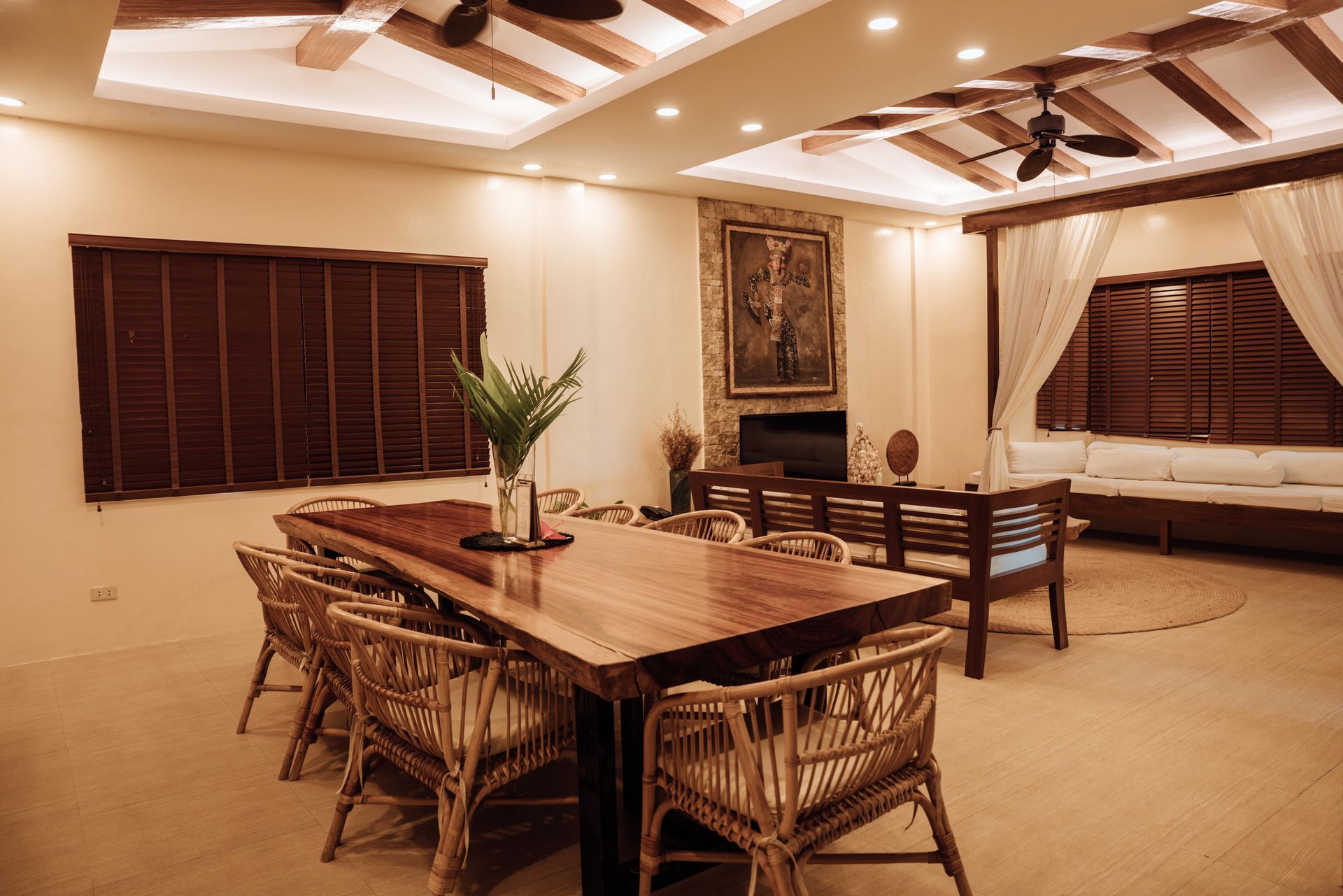 A large dining room with a wooden table and chairs.