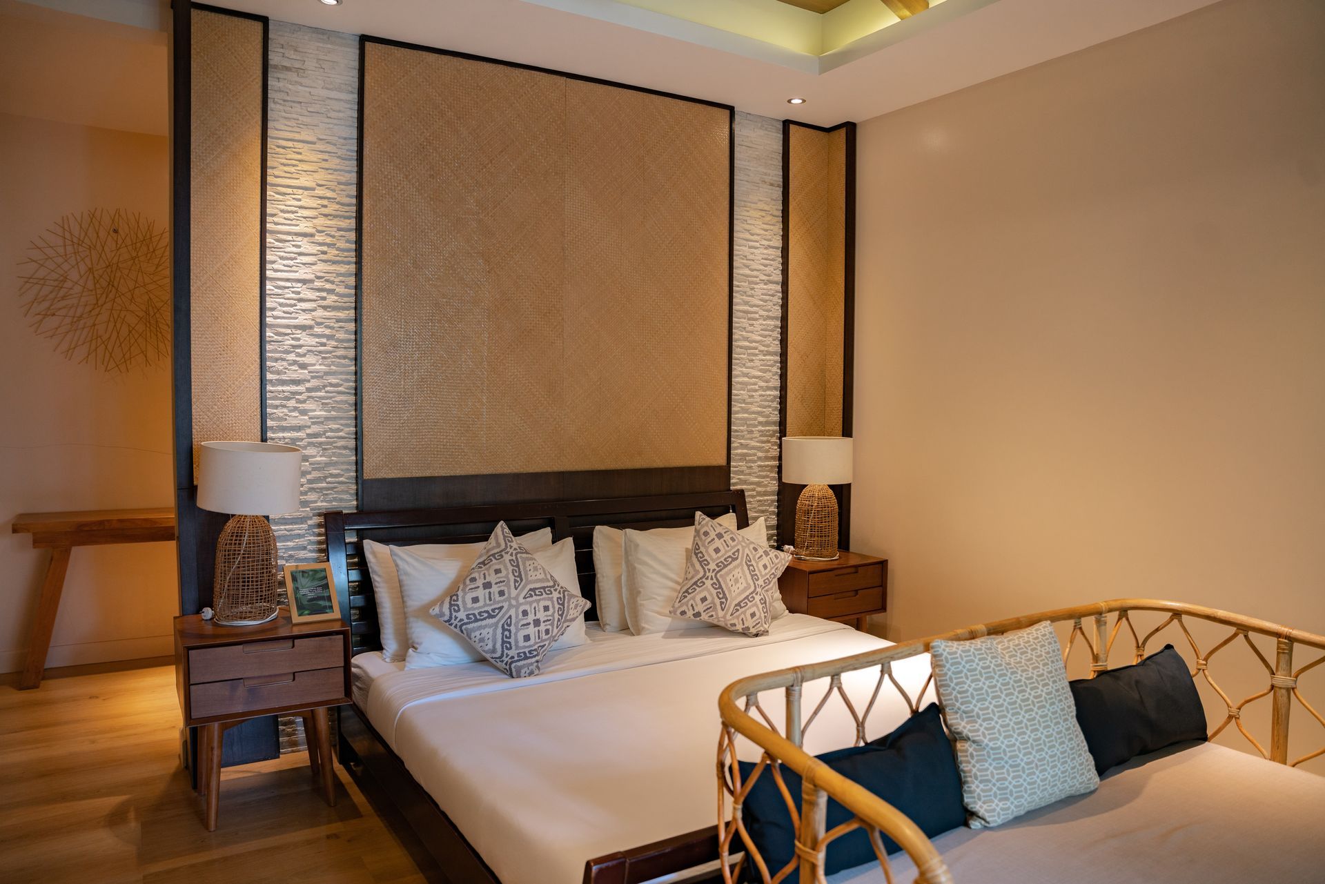 A bedroom with a large bed and a couch.