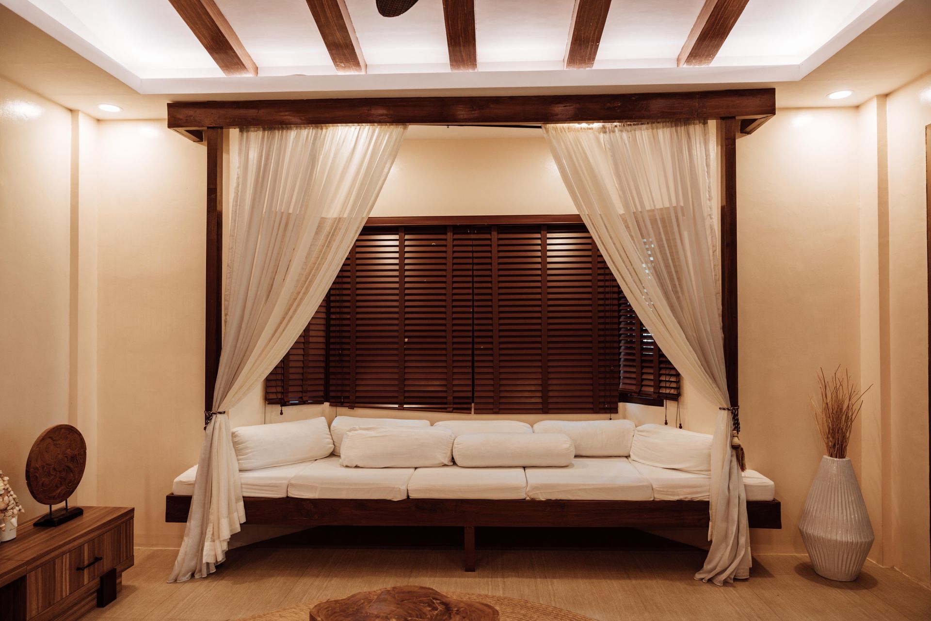 A living room with a canopy bed and a couch.