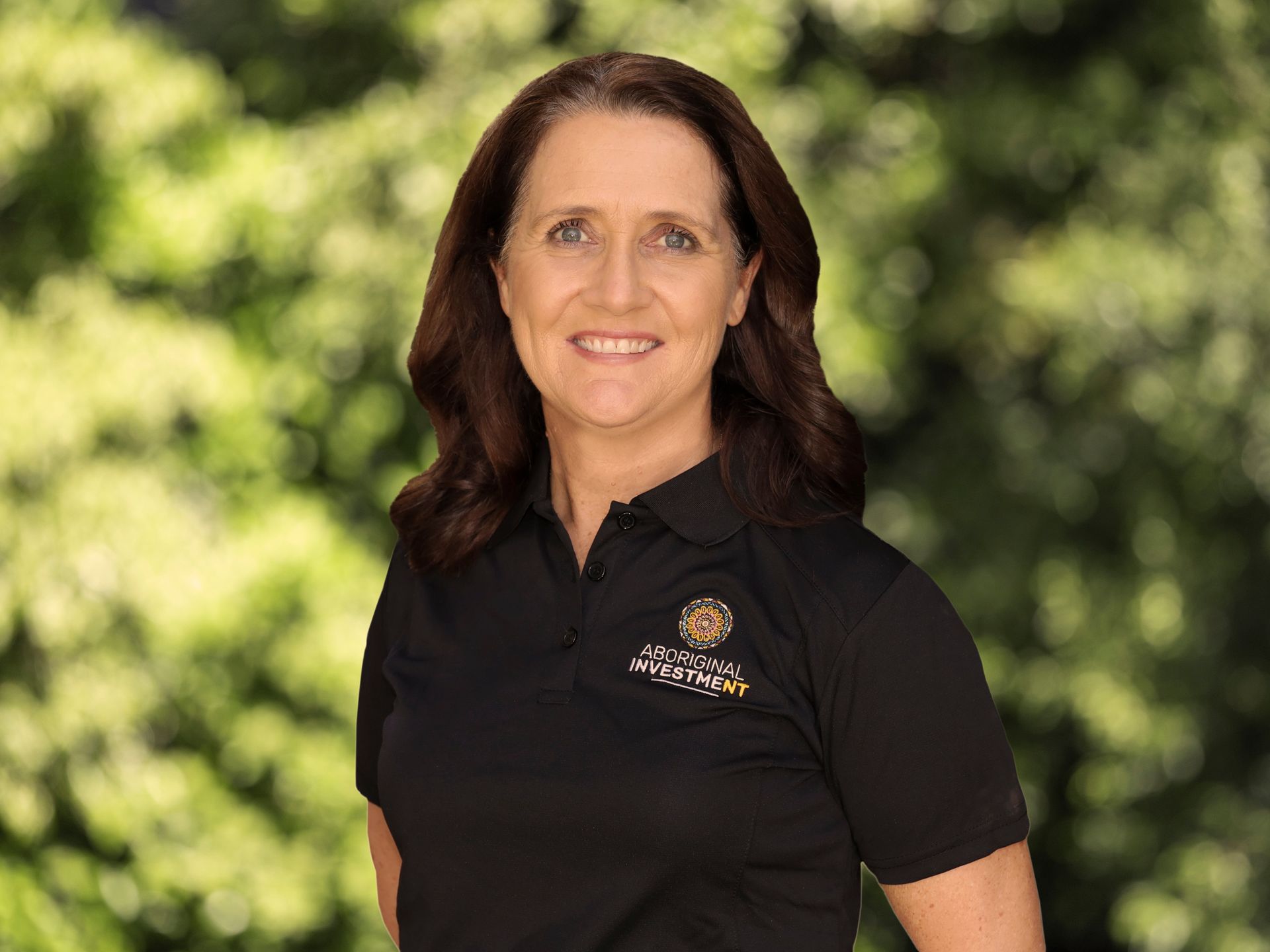 A woman in a black shirt is smiling for the camera.