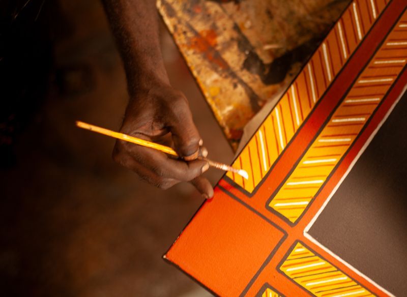 A person is painting a picture with a brush