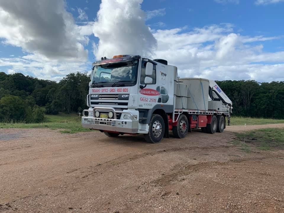 A Truck is Parked on a Dirt Road in a Field — Graham's Precast Concrete Products Pty Ltd in Kyogle, NSW