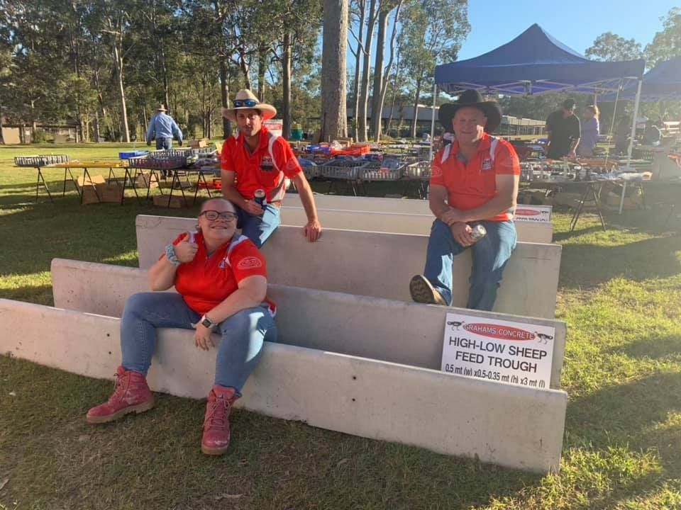 A Group of People Are Sitting on a Bench in a Park — Graham's Precast Concrete Products Pty Ltd in Kyogle, NSW