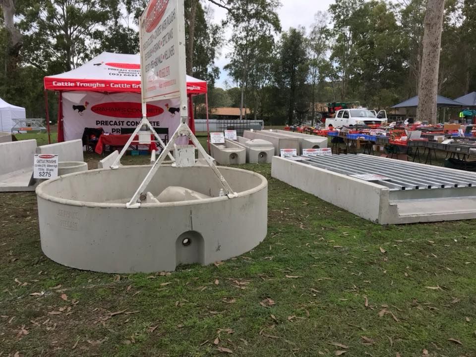 A Large Concrete Ring is Sitting on Top of a Lush Green Field — Graham's Precast Concrete Products Pty Ltd in Kyogle, NSW