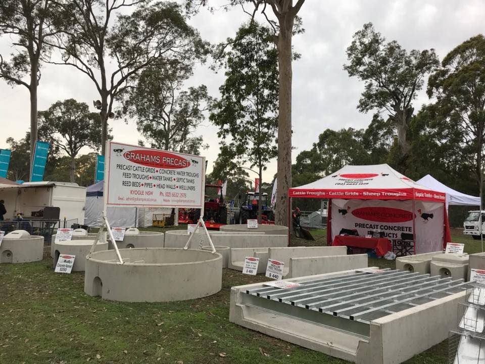 A Group of Tents Are Sitting on Top of a Lush Green Field — Graham's Precast Concrete Products Pty Ltd in Kyogle, NSW