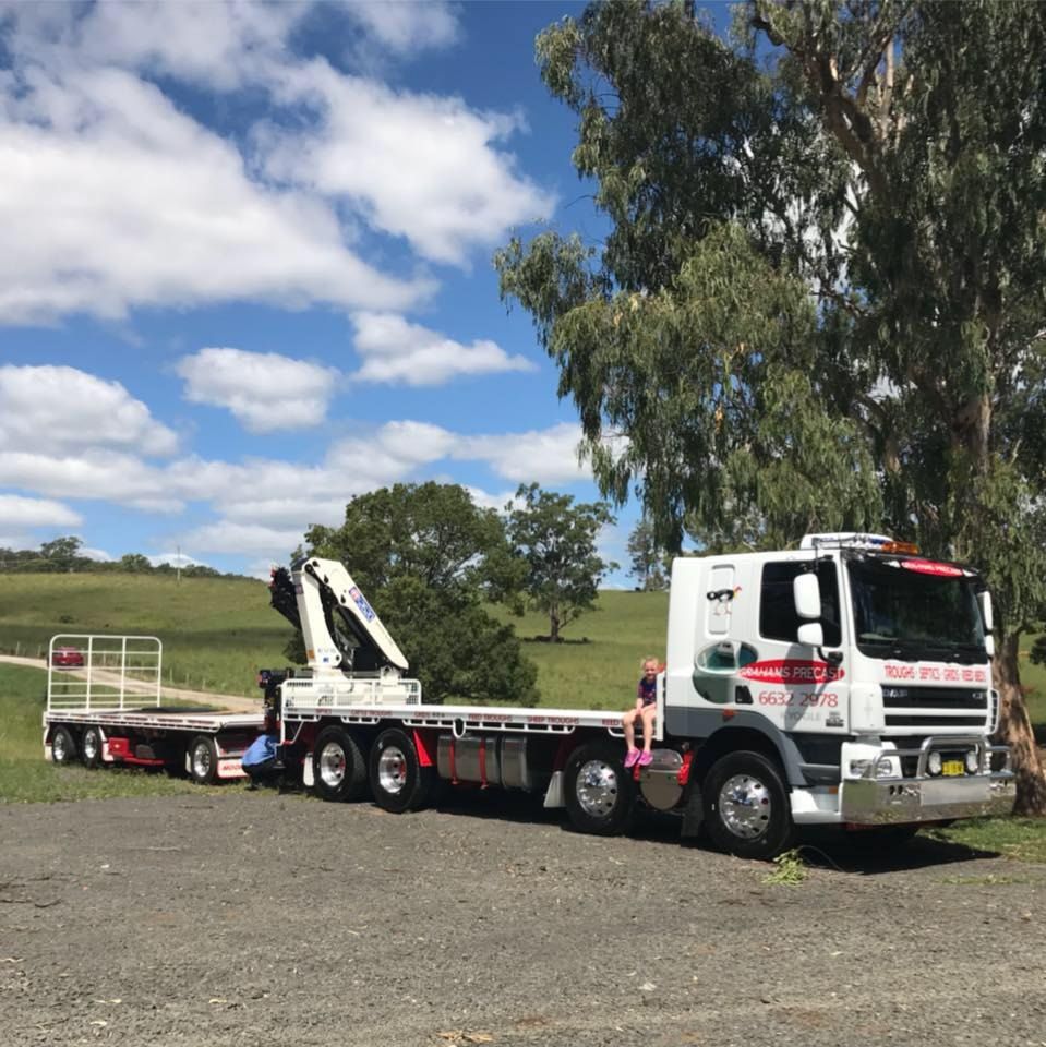 A Flatbed Truck With a Crane Attached to It — Graham's Precast Concrete Products Pty Ltd in Kyogle, NSW