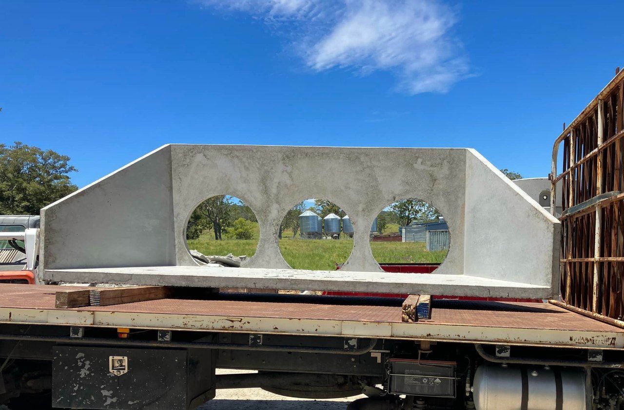 A Large Piece of Concrete is Sitting on the Back of a Truck — Graham's Precast Concrete Products Pty Ltd in Kyogle, NSW