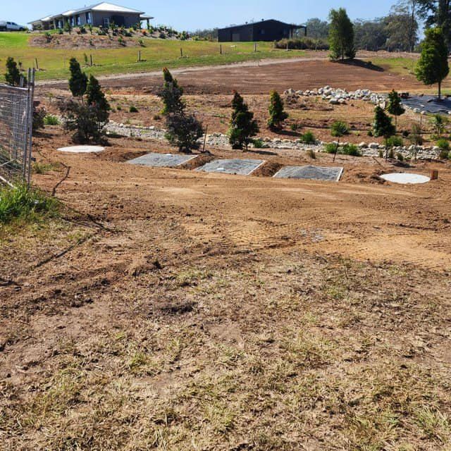 A Dirt Field With a House in the Background — Graham's Precast Concrete Products Pty Ltd in Kyogle, NSW