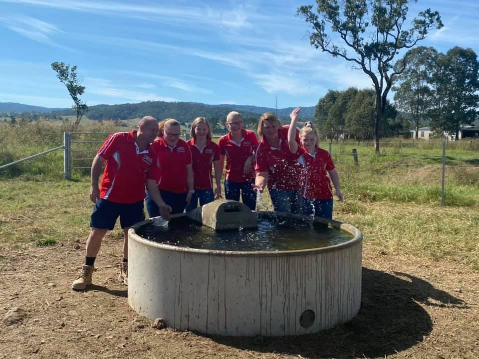 A Group of People Are Standing Around a Fountain in a Field — Graham's Precast Concrete Products Pty Ltd in Kyogle, NSW
