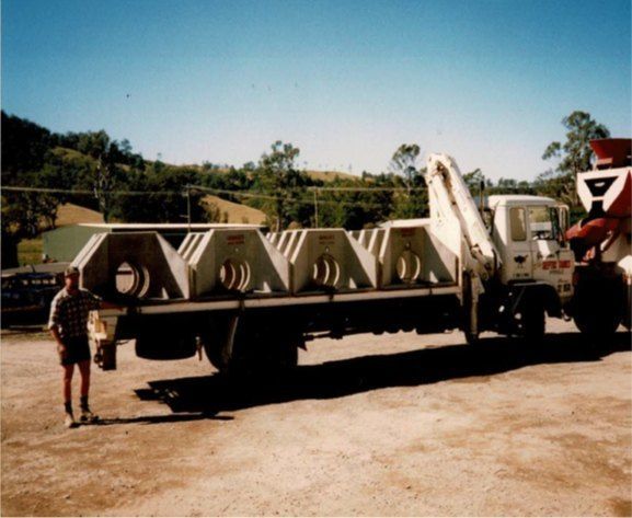 A Man Standing Next to a Truck — Graham's Precast Concrete Products Pty Ltd in Kyogle, NSW