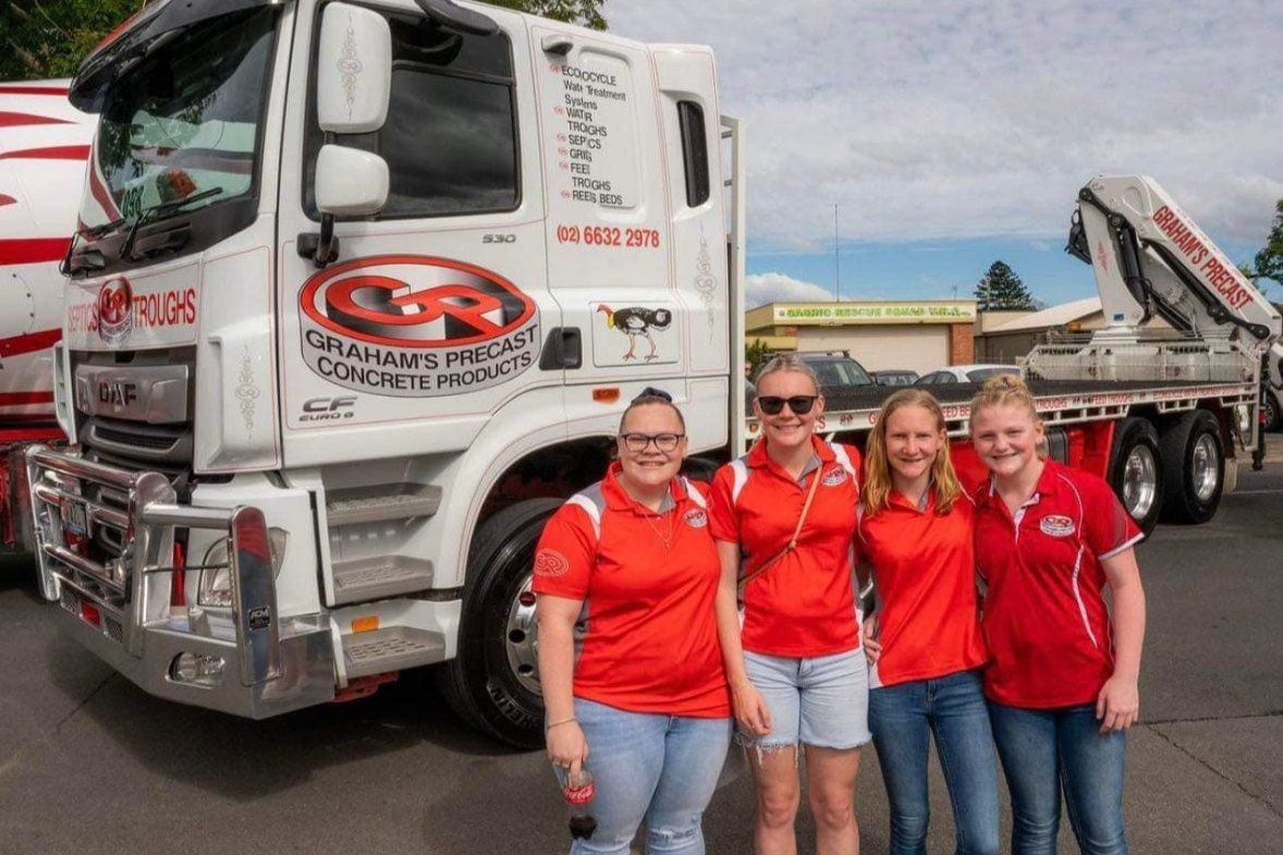 A Group of Women Are Posing for a Picture in Front of a Truck — Graham's Precast Concrete Products Pty Ltd in Kyogle, NSW