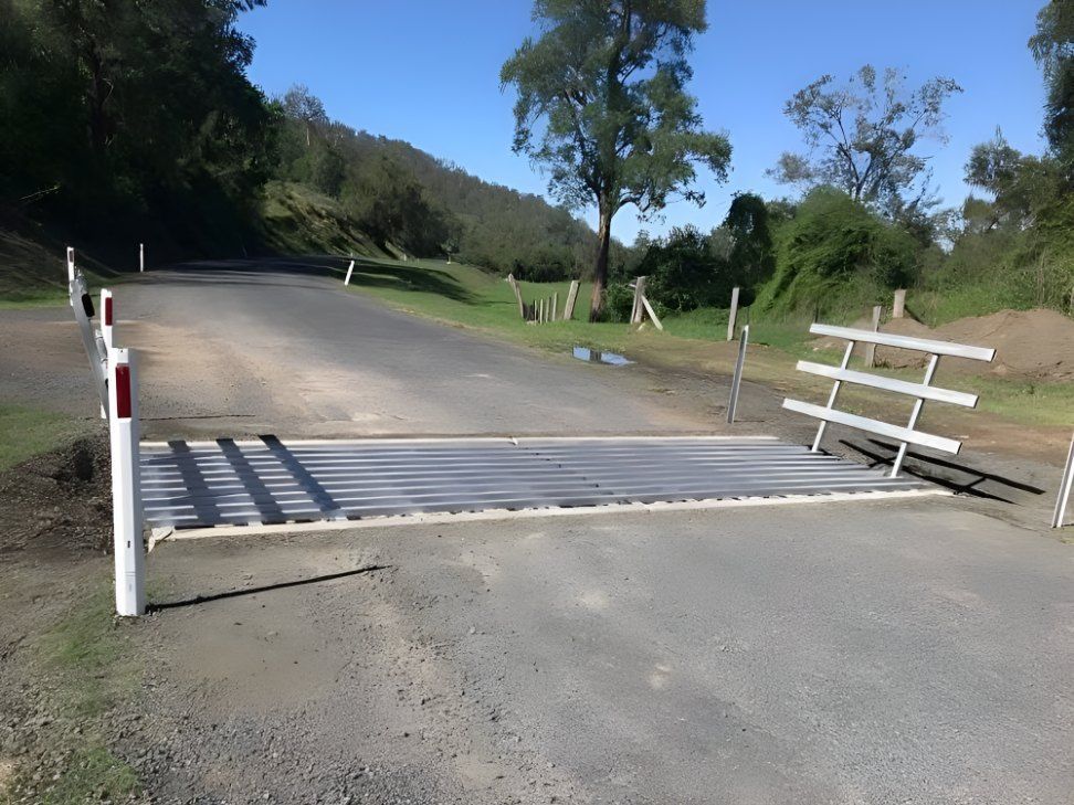 A Metal Fence is Sitting on the Side of a Road — Graham's Precast Concrete Products Pty Ltd in Kyogle, NSW