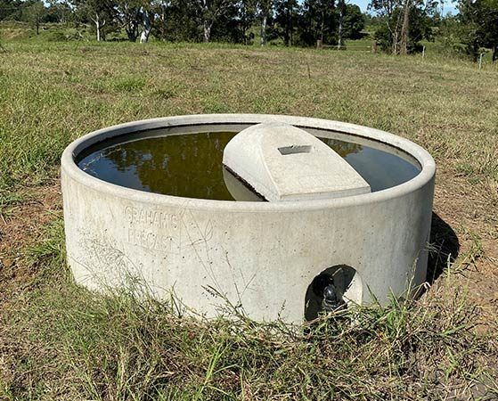 A Large Concrete Circle Filled With Water in a Field — Graham's Precast Concrete Products Pty Ltd in Kyogle, NSW