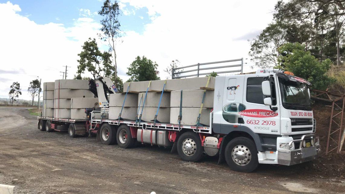 A Truck is Carrying Concrete Blocks on a Trailer — Graham's Precast Concrete Products Pty Ltd in Kyogle, NSW