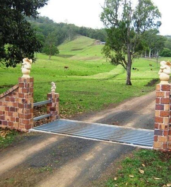 A Metal Gate Leading to a Grassy Field — Graham's Precast Concrete Products Pty Ltd in Kyogle, NSW