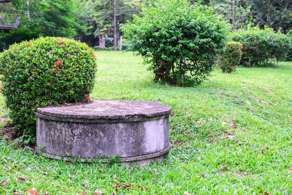 A Concrete Well In The Middle Of A Lush Green Field — Graham's Precast Concrete Products Pty Ltd in Kyogle, NSW