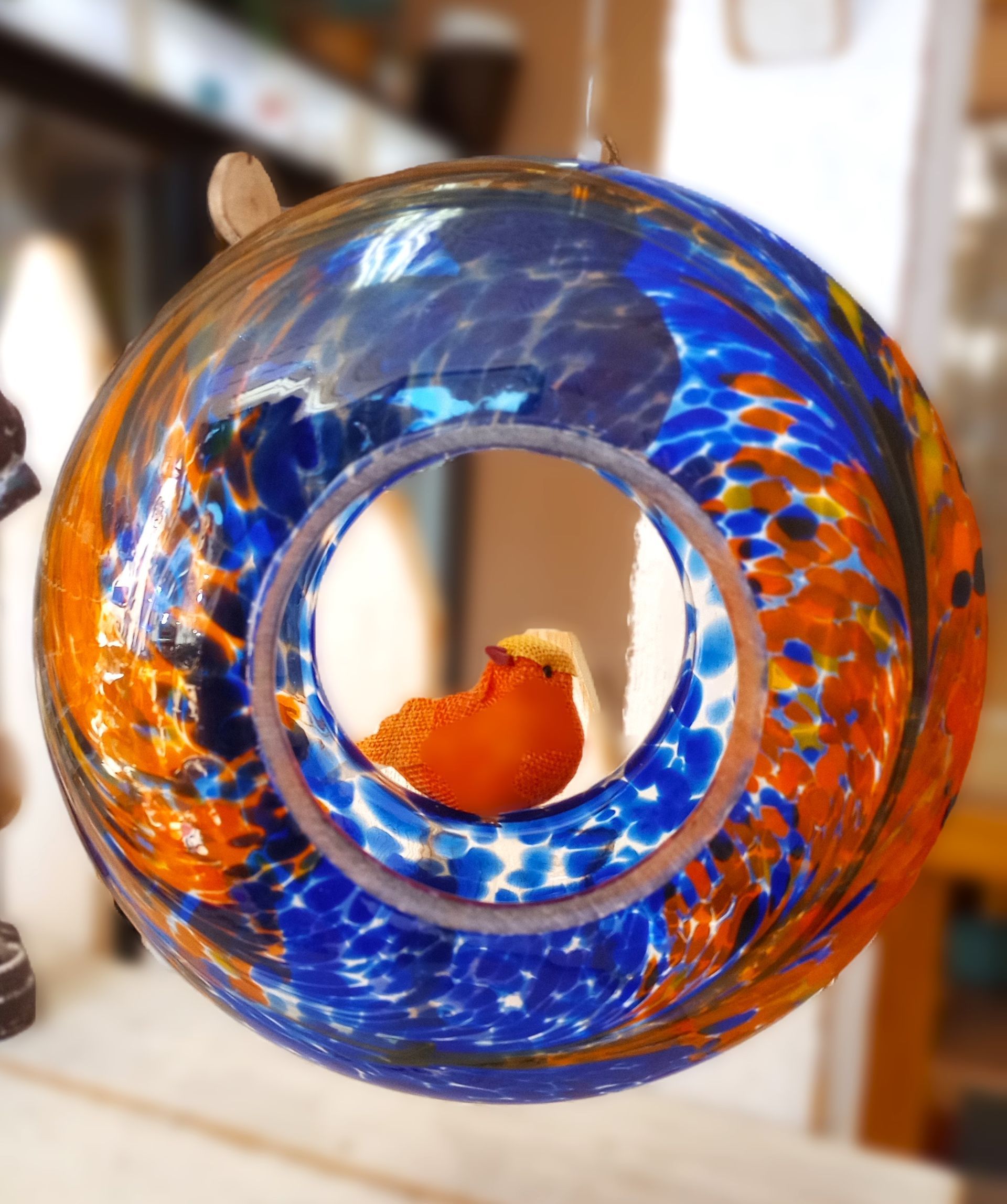 A blue and orange ring with a bird inside of it