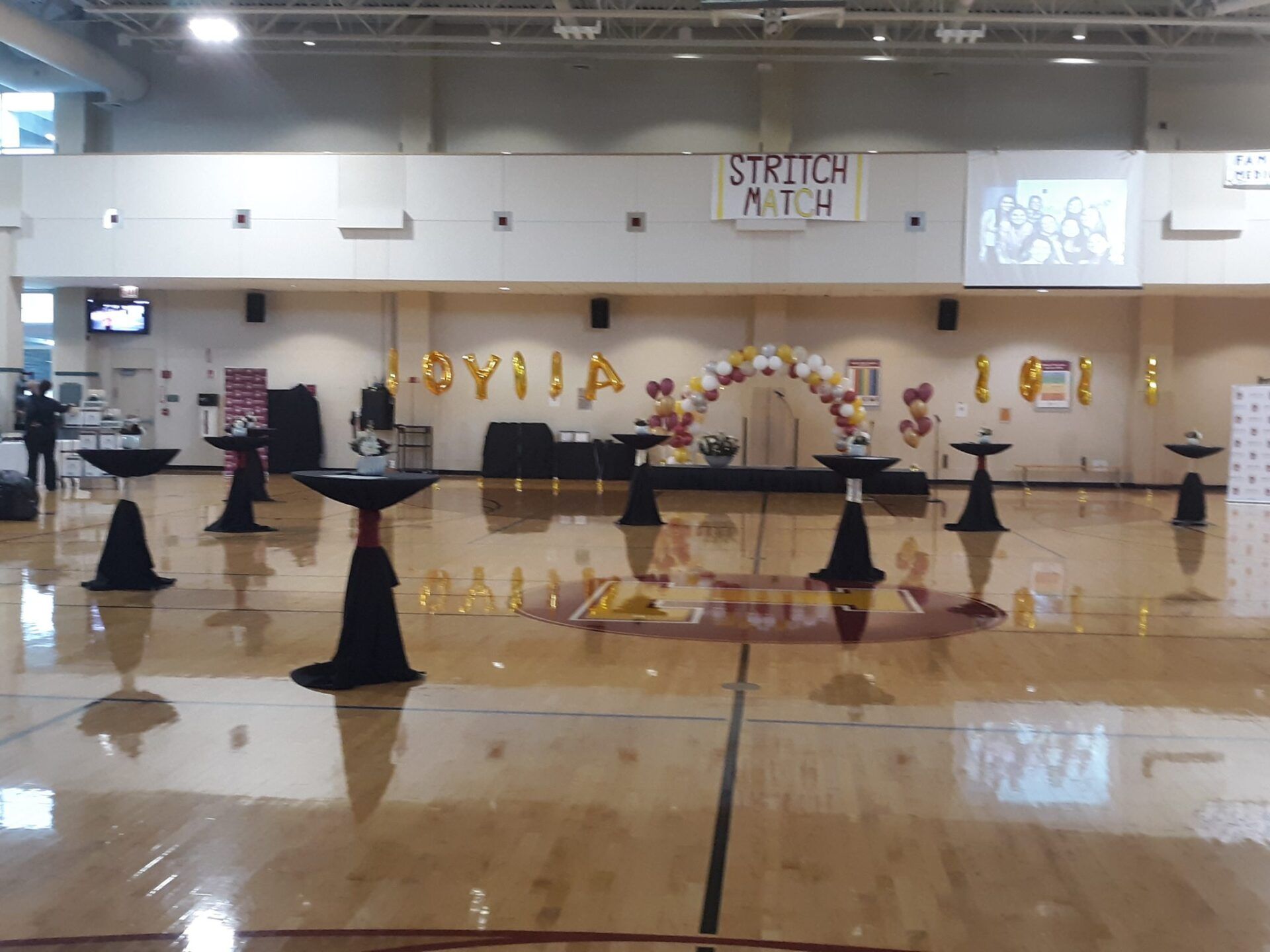 A gym with tables and a sign that says stretch ath