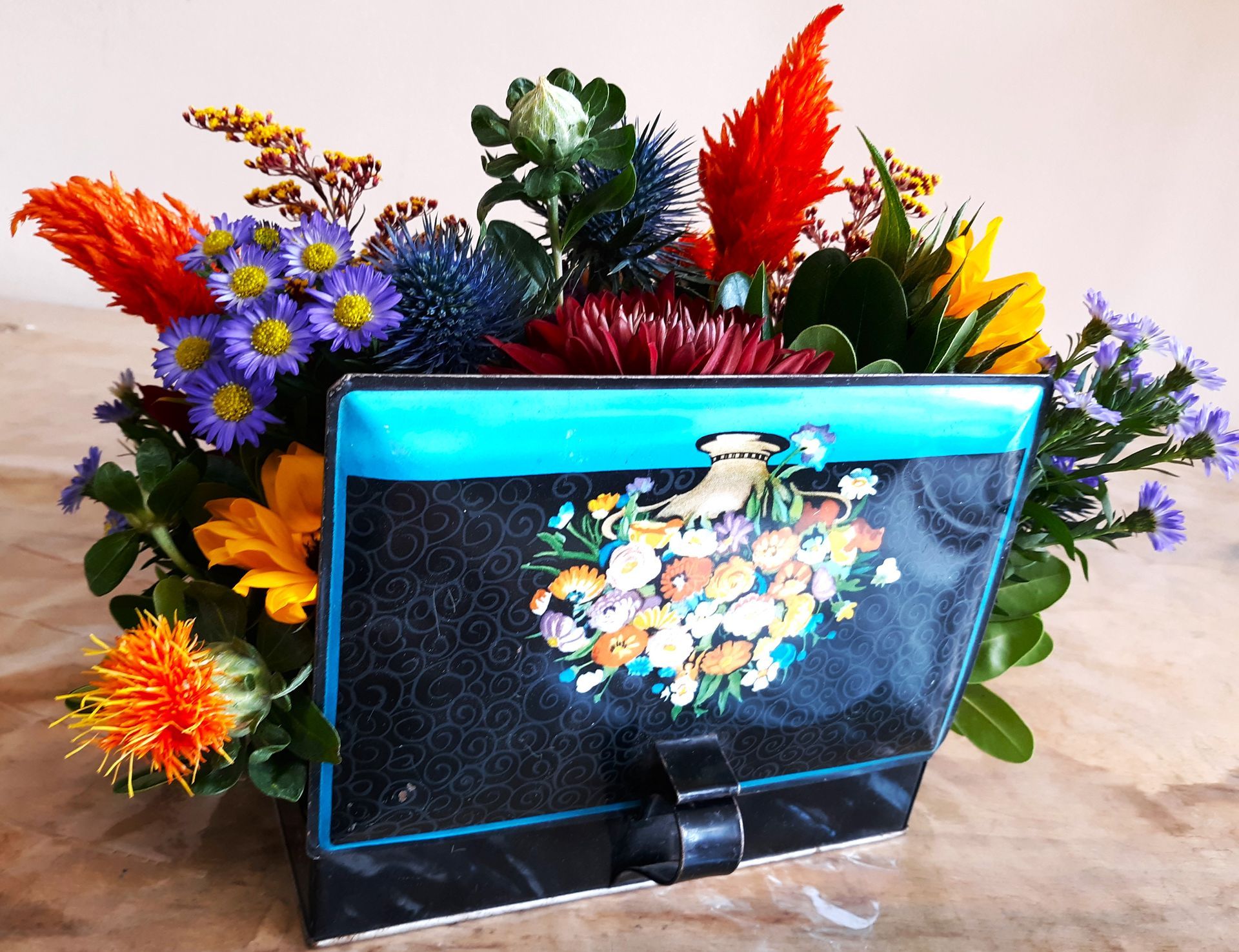 A purse filled with flowers sits on a table