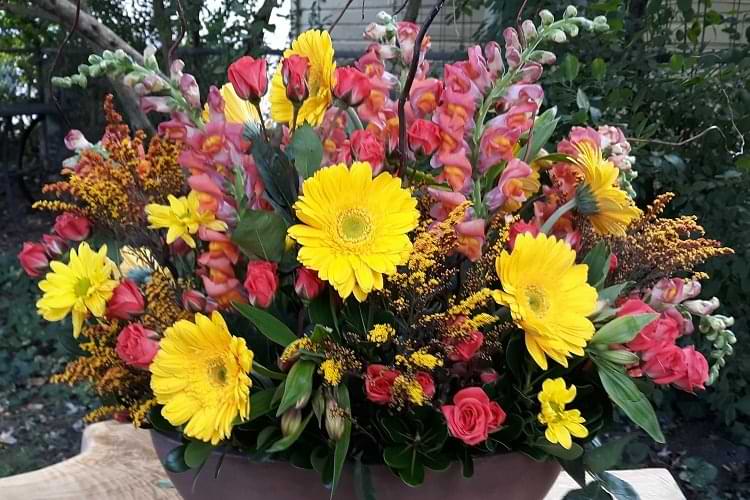 A bouquet of yellow and red flowers in a vase