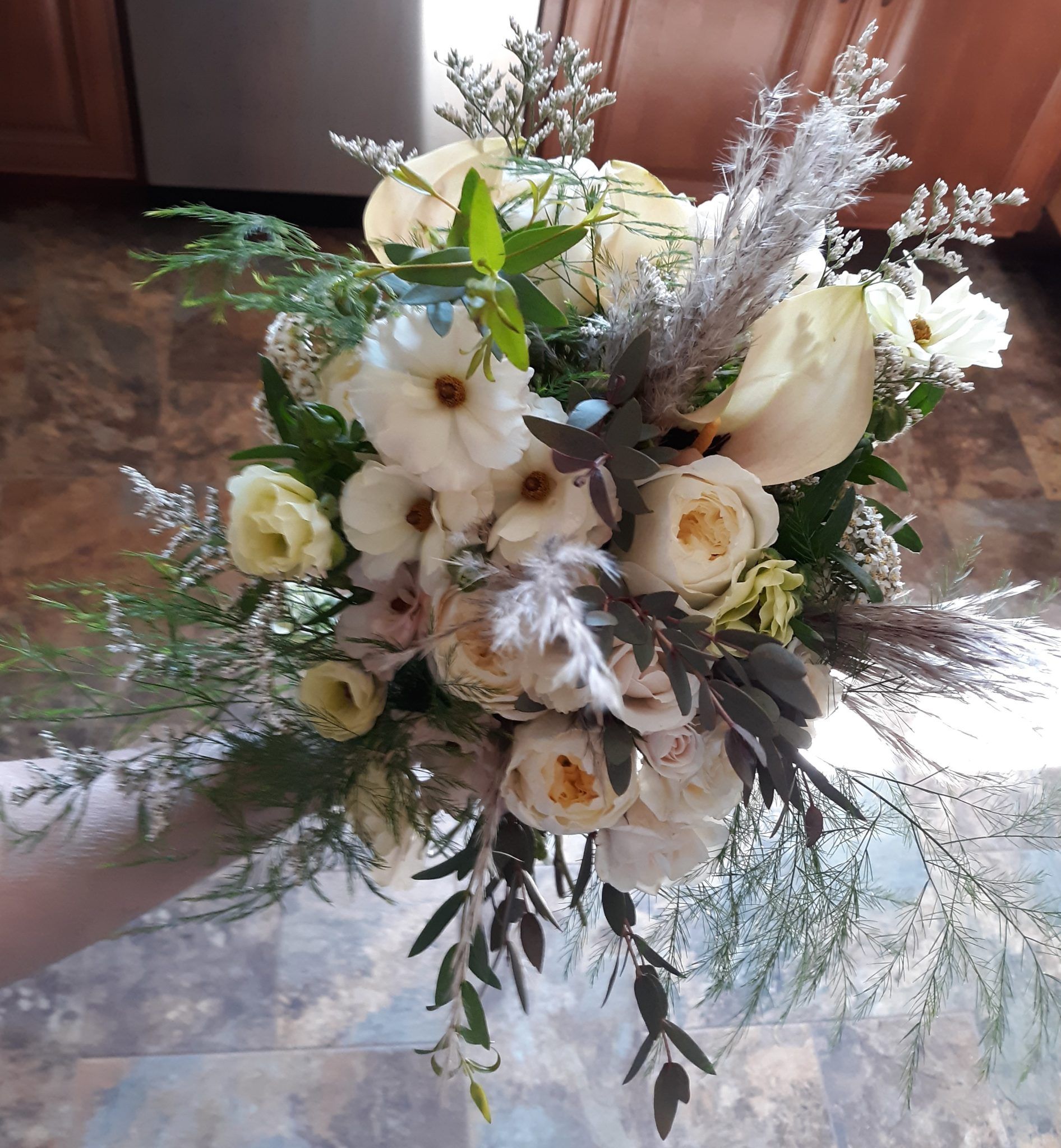 A bouquet of white flowers is sitting on the floor