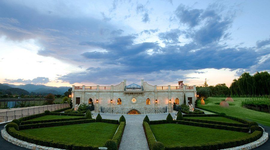 A large building with a circular lawn in front of it