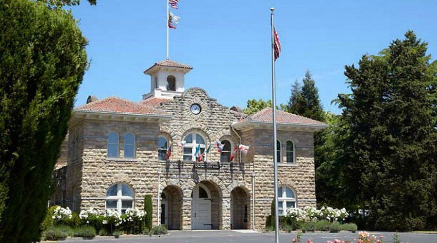 A large stone building with a flag on top of it