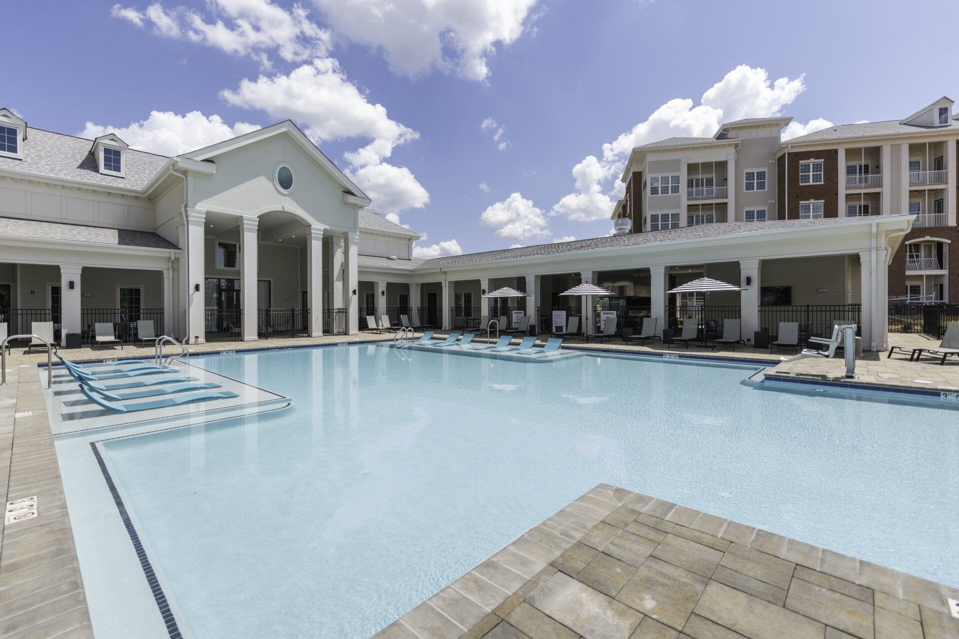 A large swimming pool in front of a building