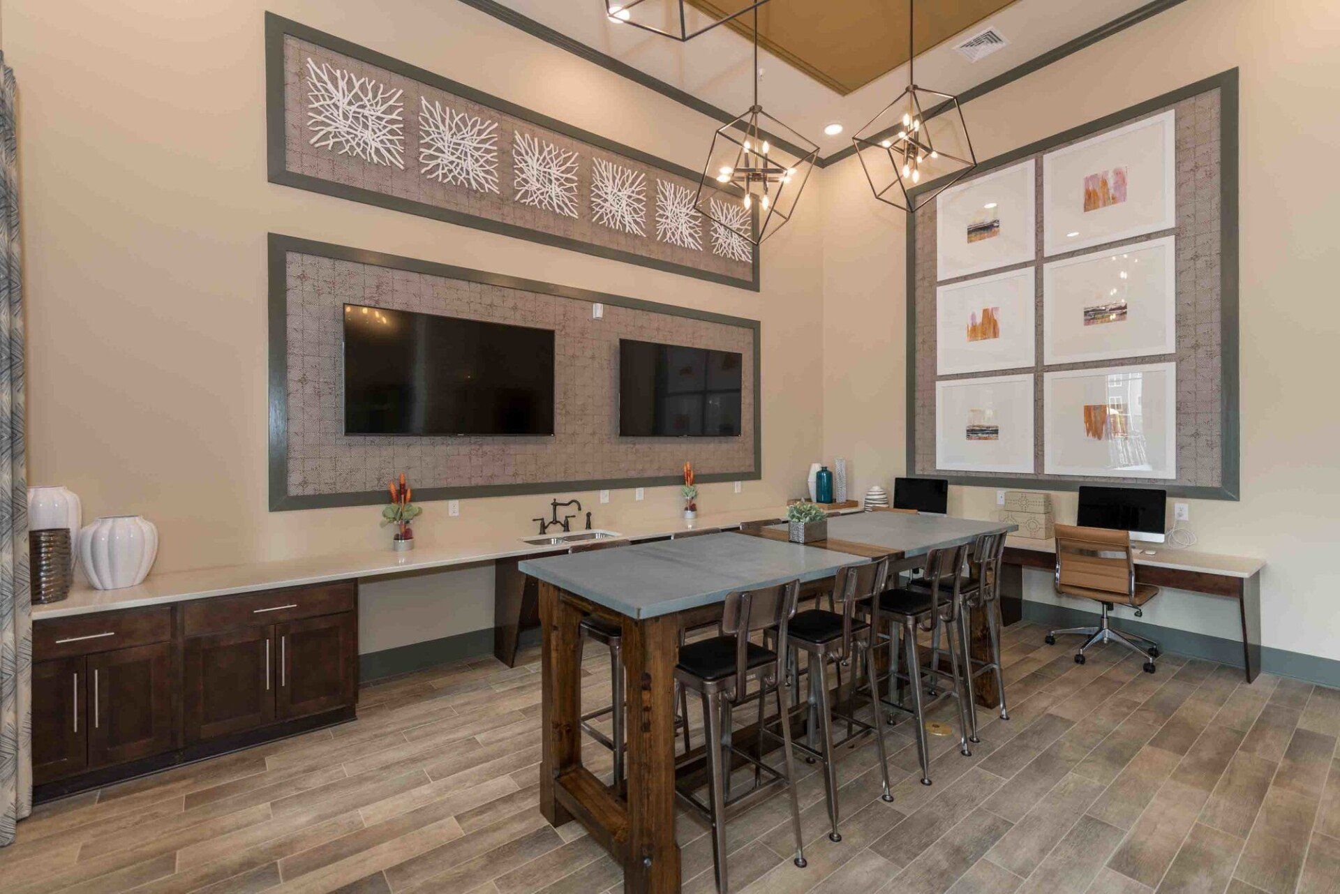 A large room with a table and chairs and a flat screen tv.